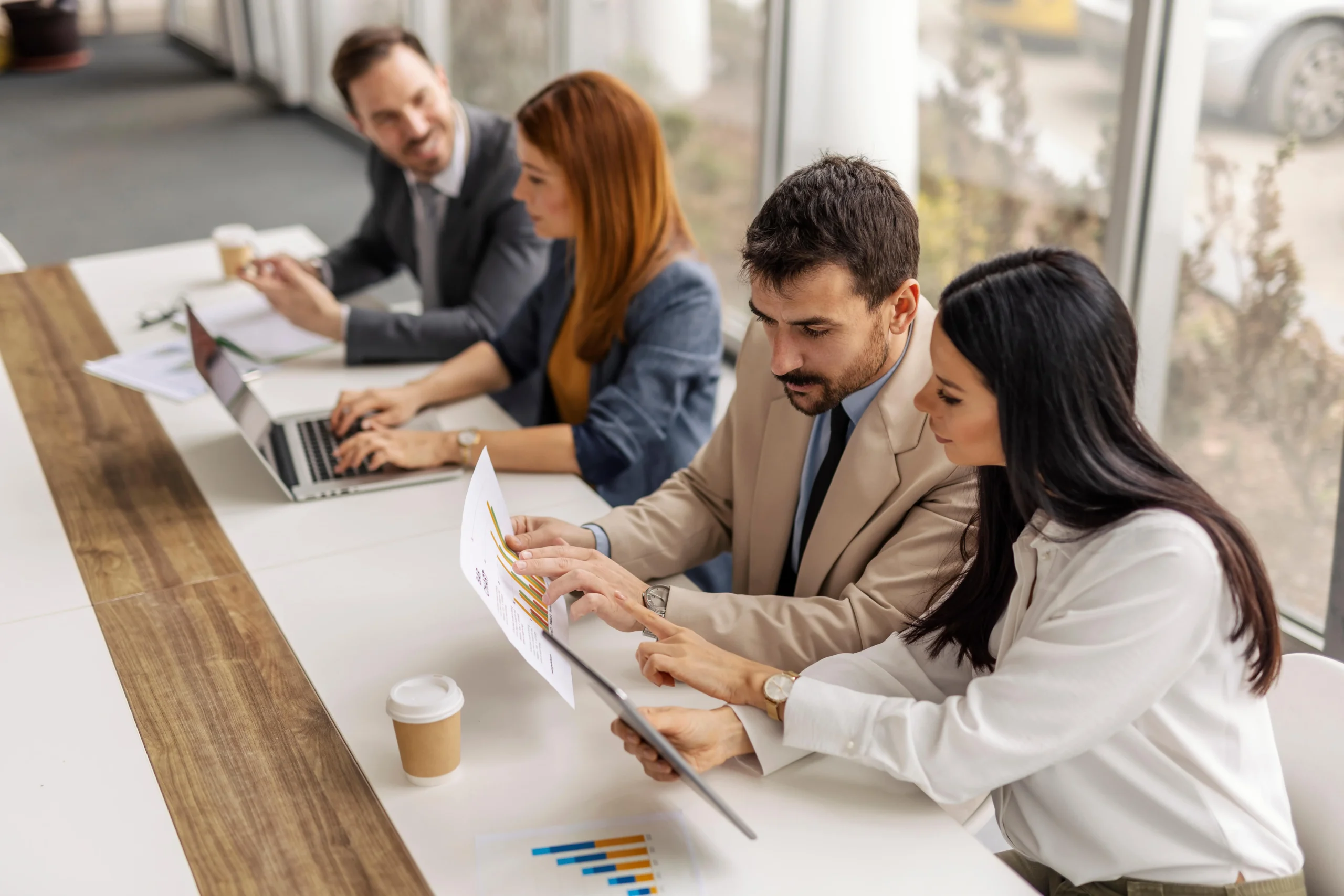 Accounting team collaborating on financial charts and reports.