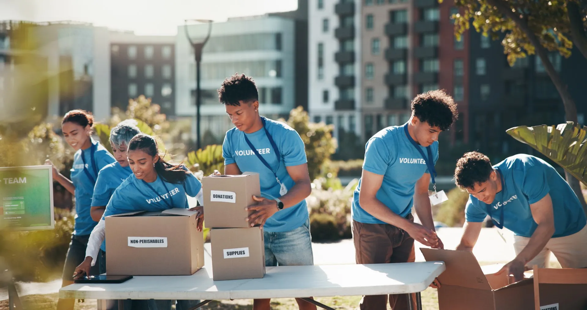 Group of volunteers organizing donation boxes at a community event.