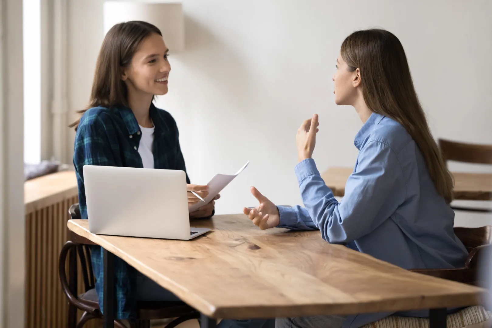 Two people in conversation, representing an onboarding discussion in a collaborative setting