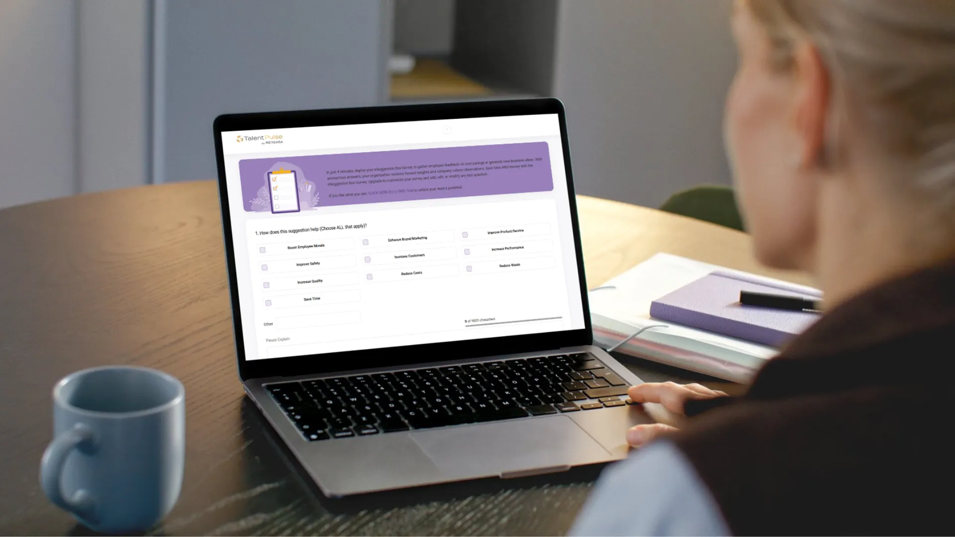 Employee completing an online eSuggestion Box survey on a laptop, representing participation in workplace innovation and feedback programs