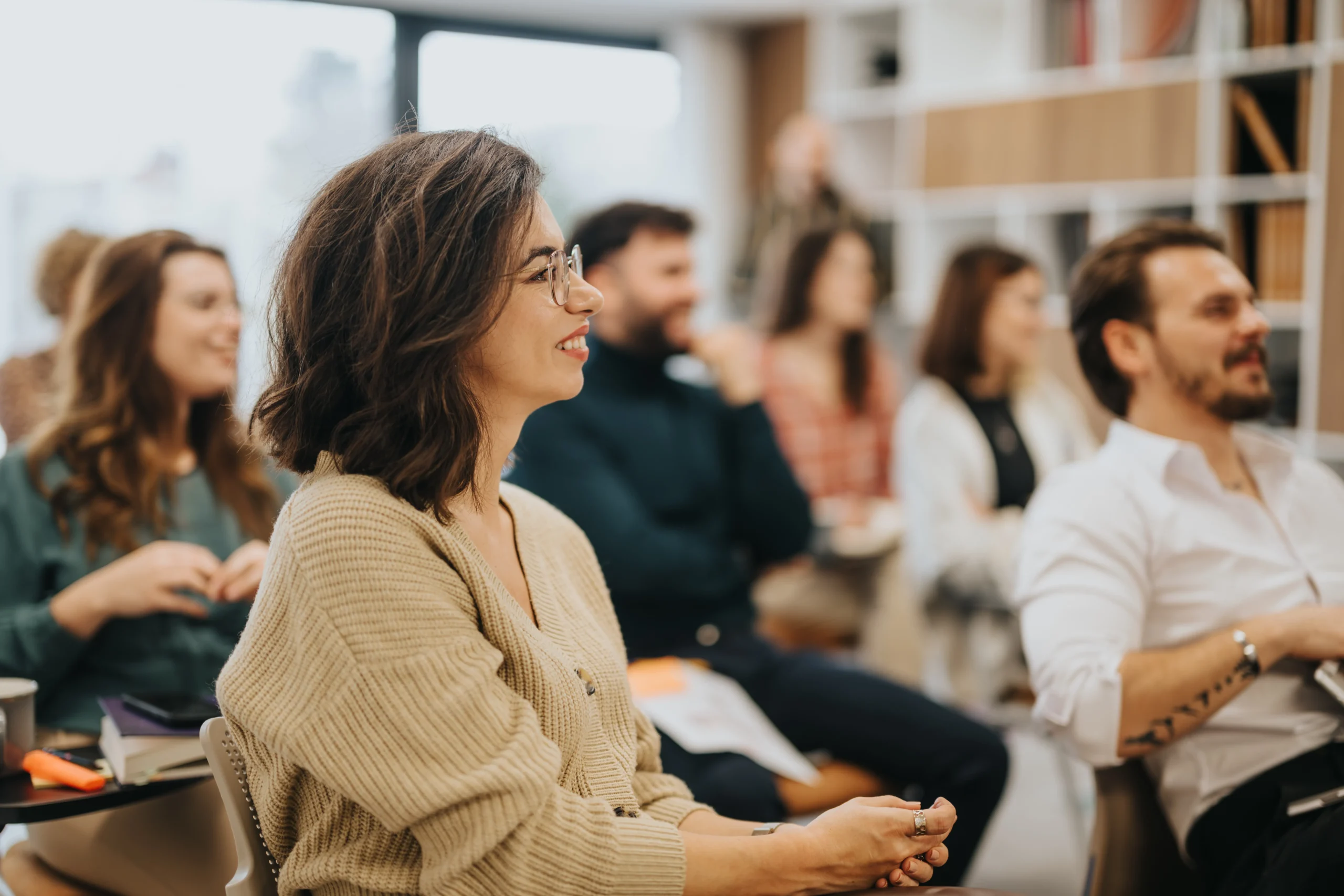 Employees attentively listening during a training workshop in a collaborative learning environment